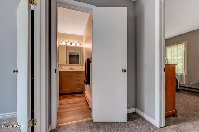 1107 Crest Cir, Lakeville, PA 18438 - hallway featuring light colored carpet, baseboards, and a sink
