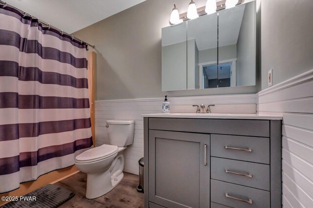 1107 Crest Cir, Lakeville, PA 18438 - bathroom featuring toilet, a wainscoted wall, vanity, wood finished floors, and a shower with curtain