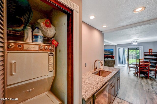 1107 Crest Cir, Lakeville, PA 18438 - kitchen featuring a sink, dishwasher, a textured ceiling, light stone counters, and open floor plan