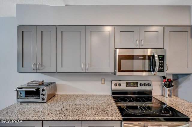 1107 Crest Cir, Lakeville, PA 18438 - kitchen featuring stainless steel appliances, gray cabinets, and light stone countertops