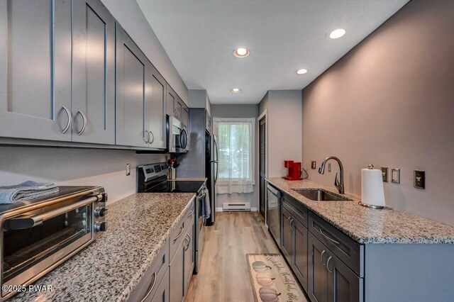 1107 Crest Cir, Lakeville, PA 18438 - kitchen with appliances with stainless steel finishes, a sink, light wood-style flooring, light stone counters, and recessed lighting