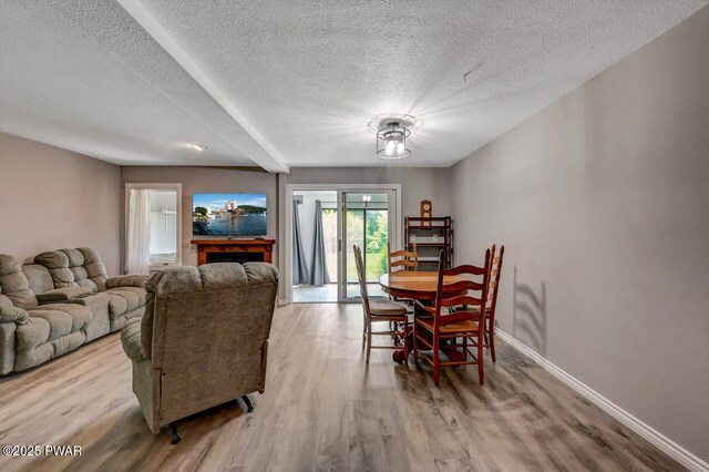 1107 Crest Cir, Lakeville, PA 18438 - living area featuring a textured ceiling, wood finished floors, and baseboards