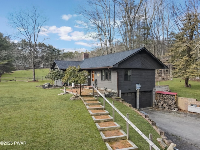 view of front of house with a front yard and a garage