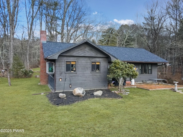 rear view of house featuring a lawn