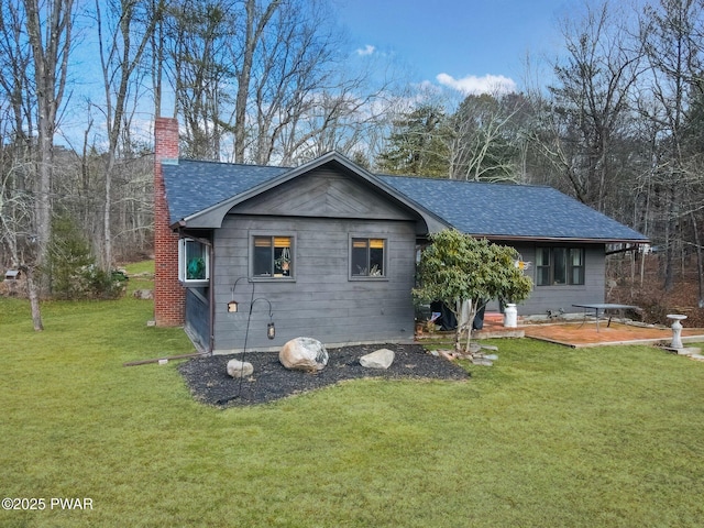 rear view of house featuring a yard