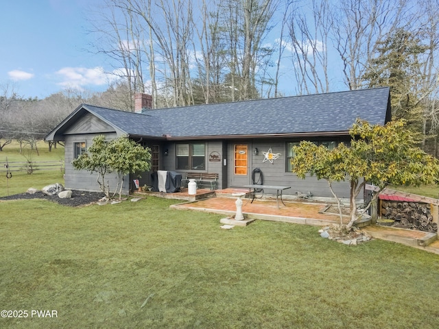 single story home with a front yard and a patio