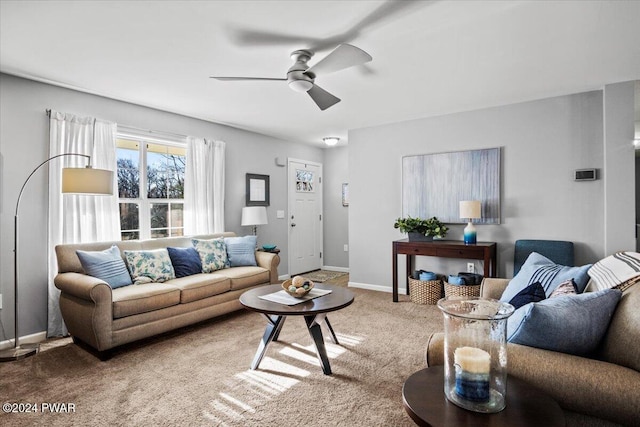 carpeted living room with ceiling fan