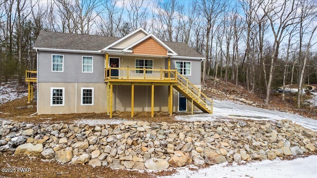 snow covered property with a deck