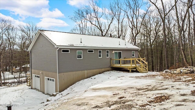 snow covered property featuring a garage