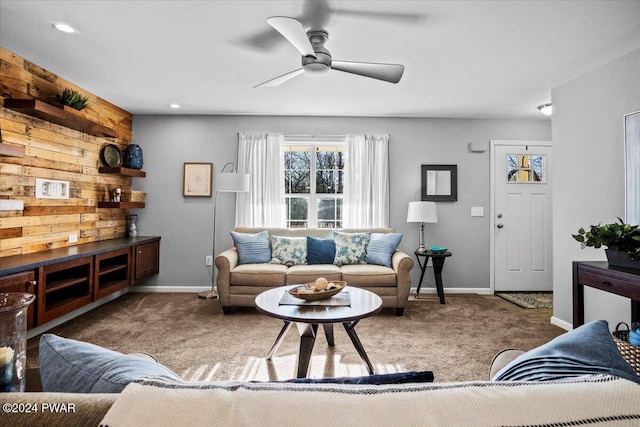 carpeted living room with ceiling fan