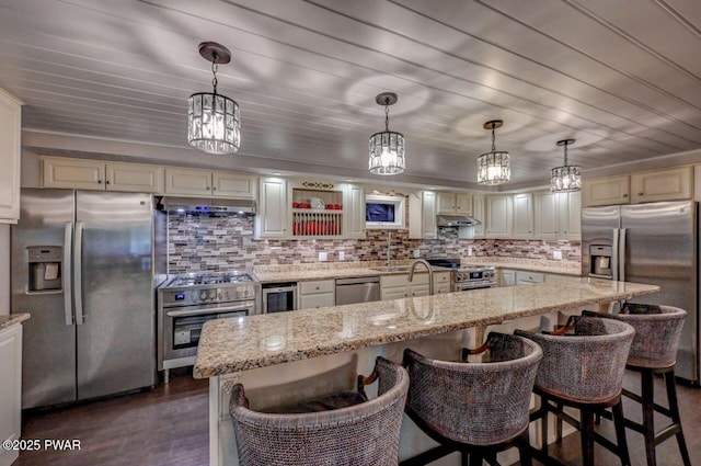 kitchen featuring appliances with stainless steel finishes, dark wood-type flooring, and tasteful backsplash