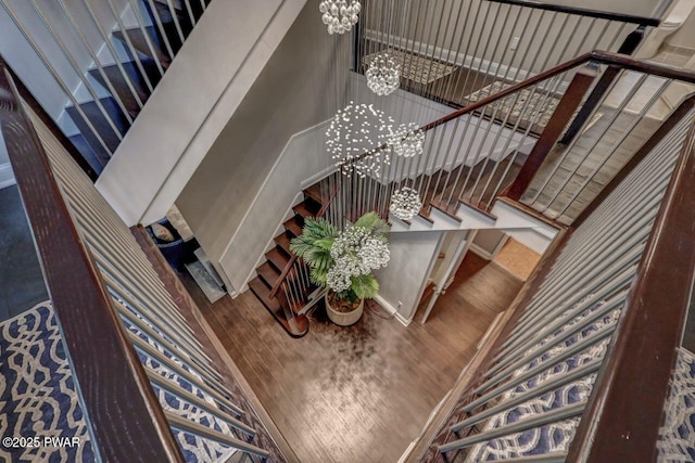 stairway with a chandelier