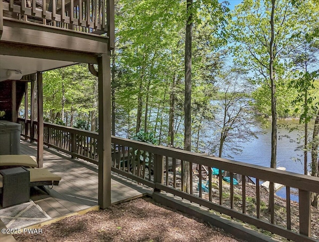 wooden terrace featuring a water view