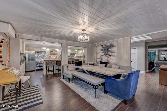 dining space with a chandelier and dark wood finished floors