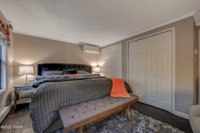bedroom with two closets, dark wood-style floors, ornamental molding, baseboards, and a wall mounted AC