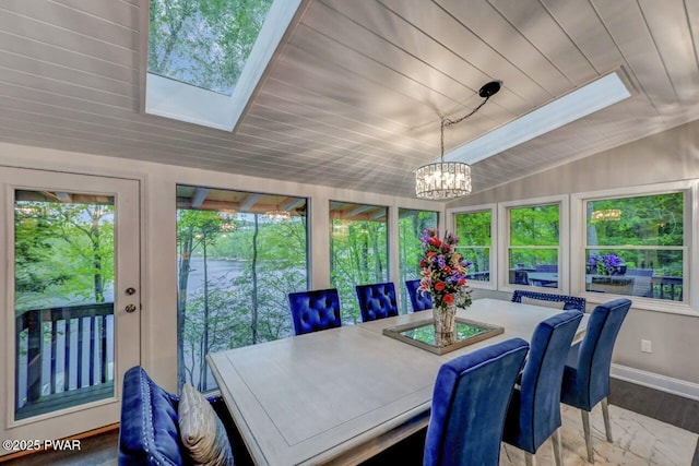 sunroom / solarium featuring a skylight, a chandelier, vaulted ceiling, baseboards, and wooden ceiling