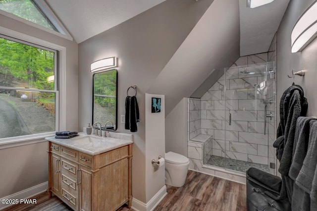full bath with vaulted ceiling, toilet, a stall shower, wood finished floors, and baseboards