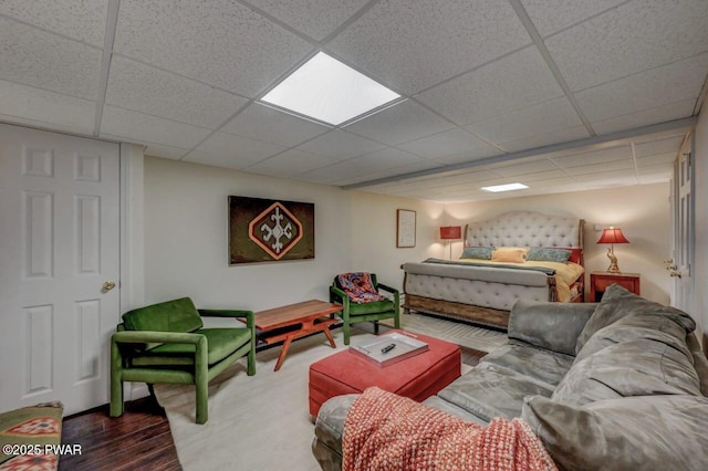 bedroom featuring a paneled ceiling and wood finished floors