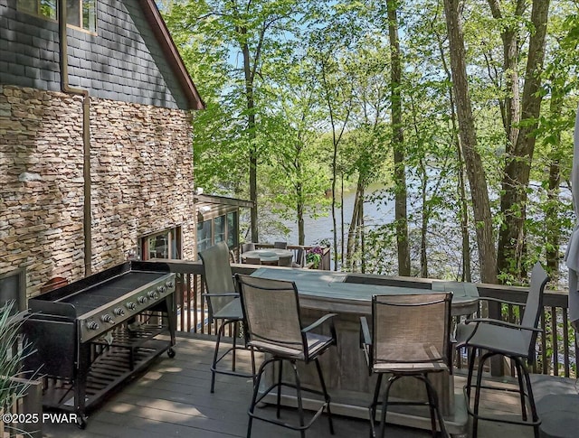 wooden deck featuring a water view and grilling area