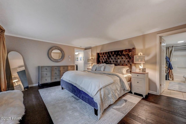 bedroom featuring hardwood / wood-style flooring, ornamental molding, and baseboards
