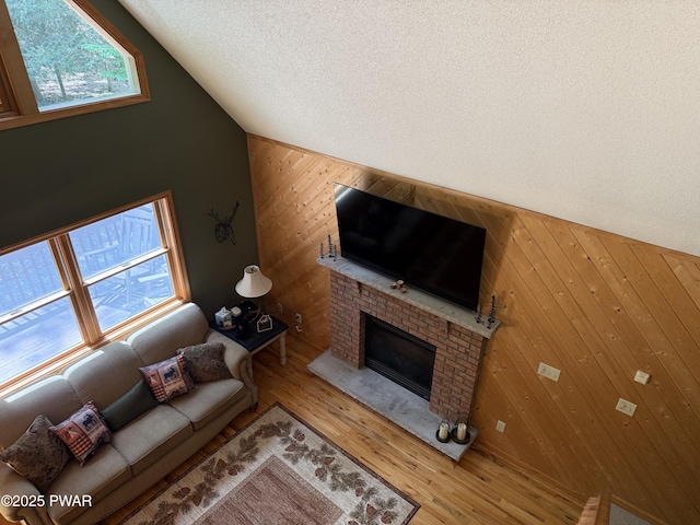 278 N Gate Rd, Lake Ariel, PA 18436 - living area featuring wooden walls, a fireplace, wood finished floors, and lofted ceiling