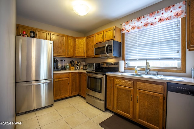 kitchen featuring light tile patterned floors, sink, and appliances with stainless steel finishes