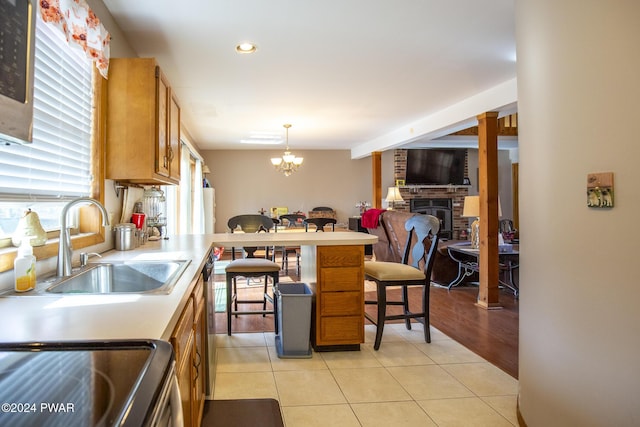 kitchen featuring a chandelier, sink, light tile patterned floors, and hanging light fixtures