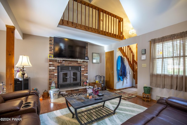 living room featuring wood-type flooring and a brick fireplace