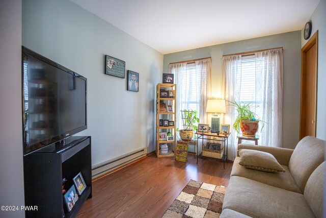 living room with hardwood / wood-style flooring and a baseboard heating unit