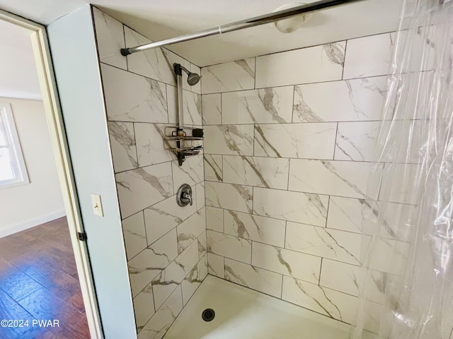 bathroom with hardwood / wood-style flooring and walk in shower