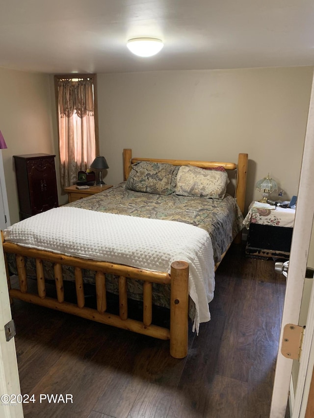 bedroom with dark wood-type flooring