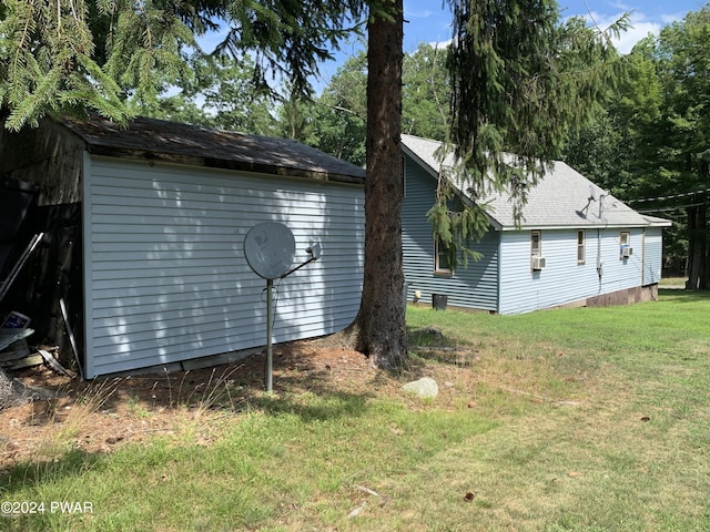 view of side of home with a lawn