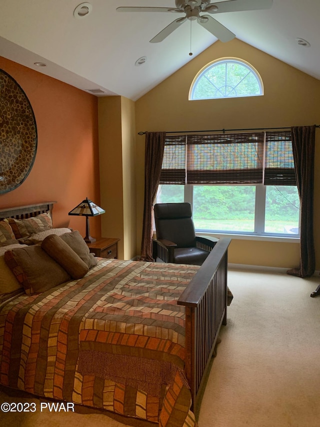 carpeted bedroom with ceiling fan and lofted ceiling