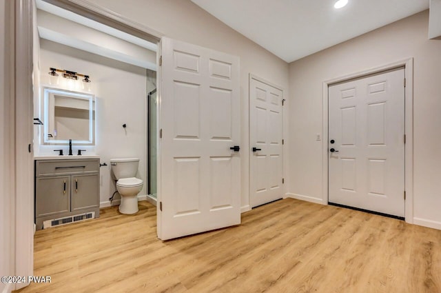 foyer entrance featuring sink and light hardwood / wood-style floors