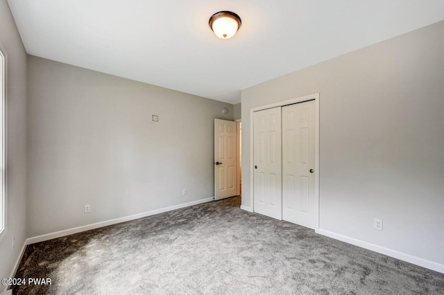 unfurnished bedroom featuring a closet and carpet floors