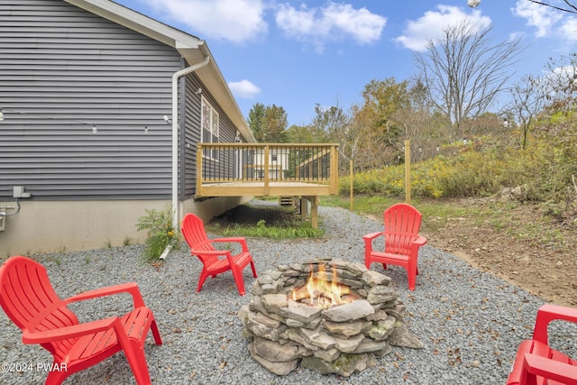 view of patio / terrace featuring a deck and an outdoor fire pit