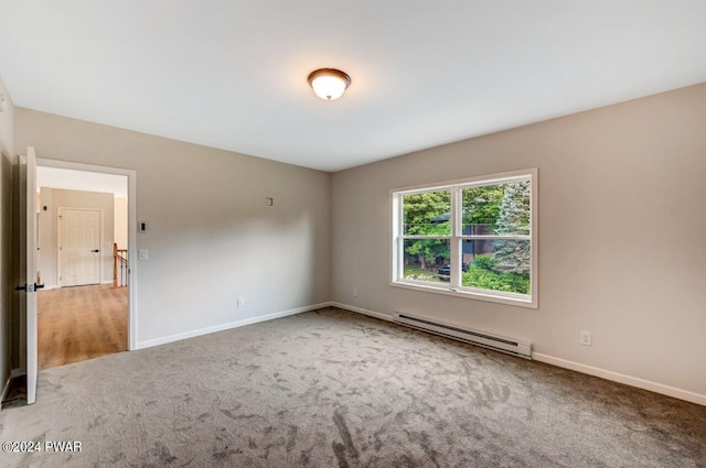 carpeted spare room featuring a baseboard radiator