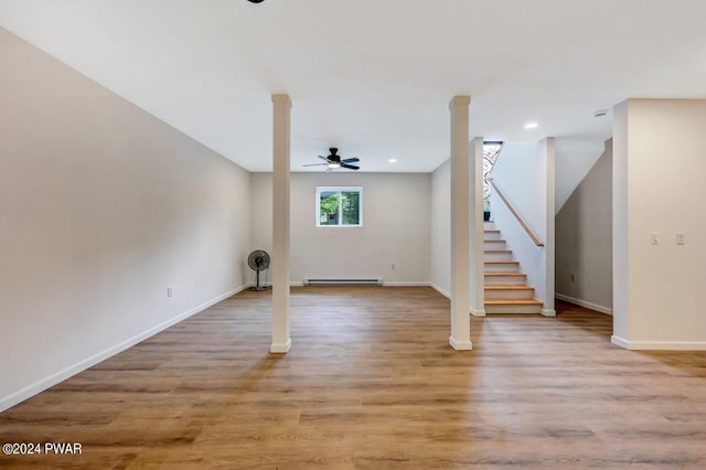 interior space featuring baseboard heating, ceiling fan, and light hardwood / wood-style flooring