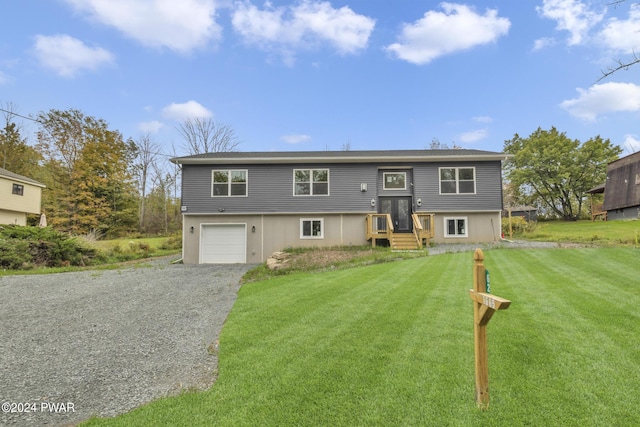 bi-level home with a garage and a front yard