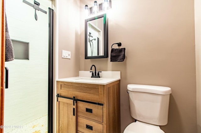 bathroom with vanity, toilet, and walk in shower