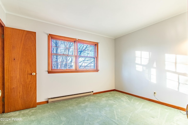 empty room with carpet, ornamental molding, and a baseboard heating unit