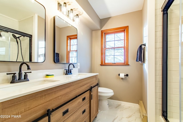 bathroom featuring vanity, toilet, and an enclosed shower