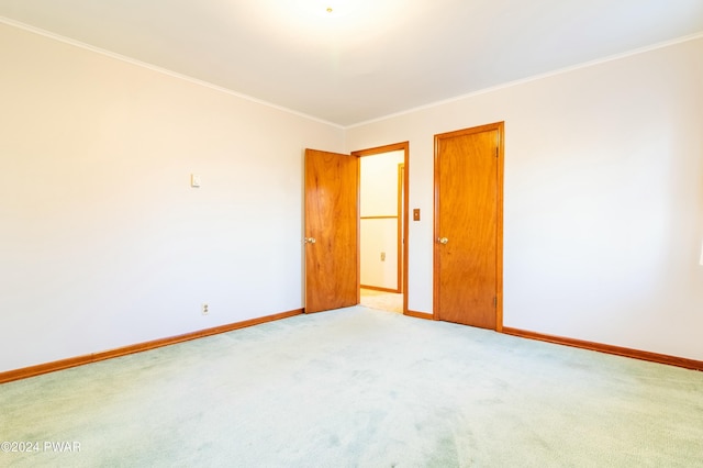 carpeted spare room with ornamental molding