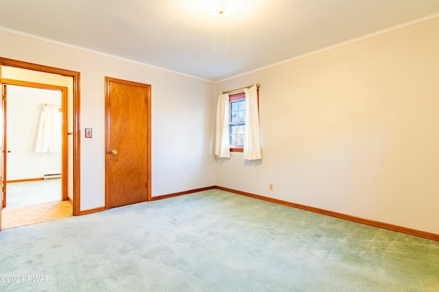 carpeted spare room featuring ornamental molding