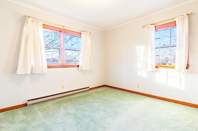 empty room featuring carpet, ornamental molding, a wealth of natural light, and a baseboard heating unit