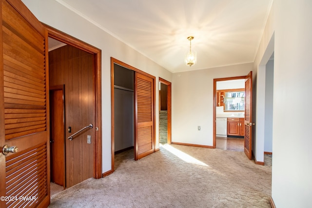 unfurnished bedroom featuring carpet flooring and a notable chandelier