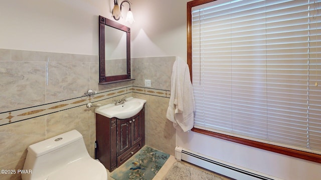 109 Lake Dr, Dingmans Ferry, PA 18328 - half bathroom featuring a baseboard radiator, tile walls, and vanity
