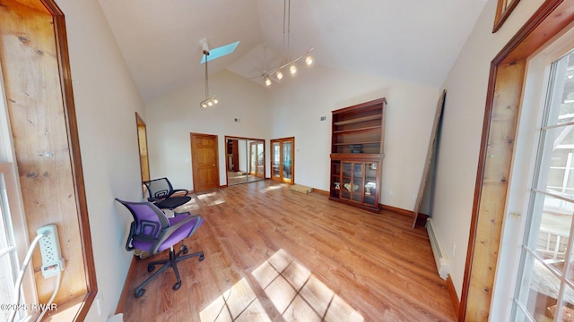 109 Lake Dr, Dingmans Ferry, PA 18328 - sitting room with light wood finished floors, plenty of natural light, baseboard heating, and high vaulted ceiling