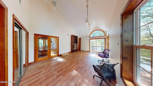 109 Lake Dr, Dingmans Ferry, PA 18328 - sitting room with french doors, high vaulted ceiling, light wood-style flooring, ceiling fan, and a baseboard radiator