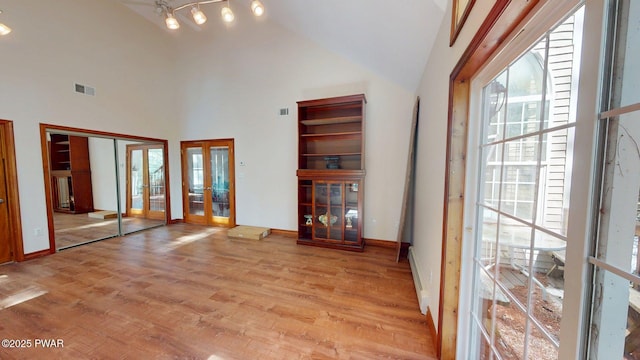 109 Lake Dr, Dingmans Ferry, PA 18328 - unfurnished living room featuring french doors, light wood-type flooring, and high vaulted ceiling